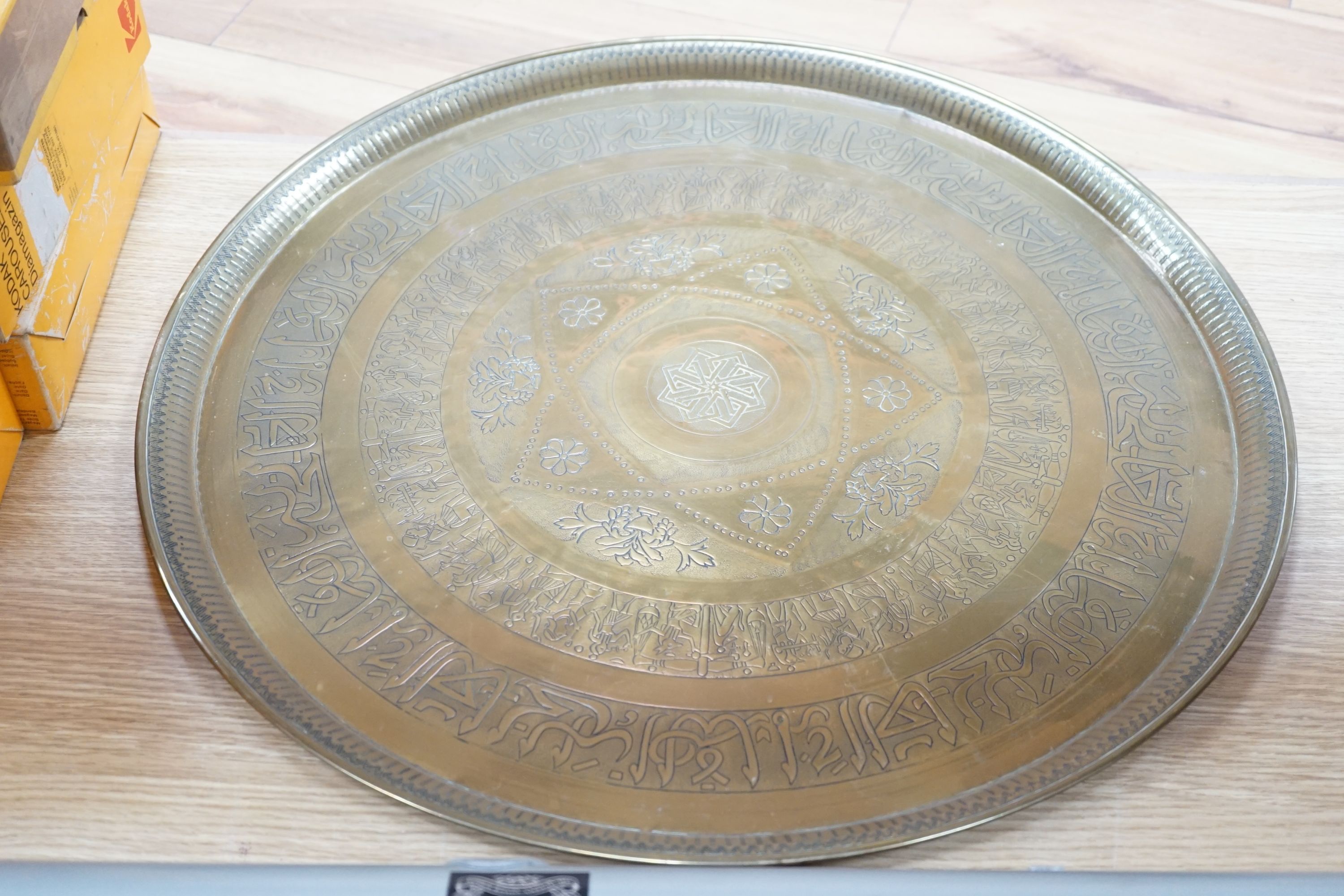 Two 19th century engraved brass circular trays, largest 58cm diameter